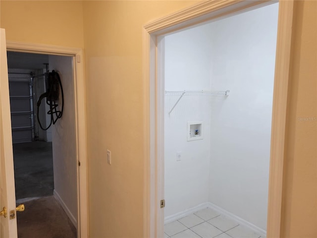 washroom with washer hookup and light tile patterned floors