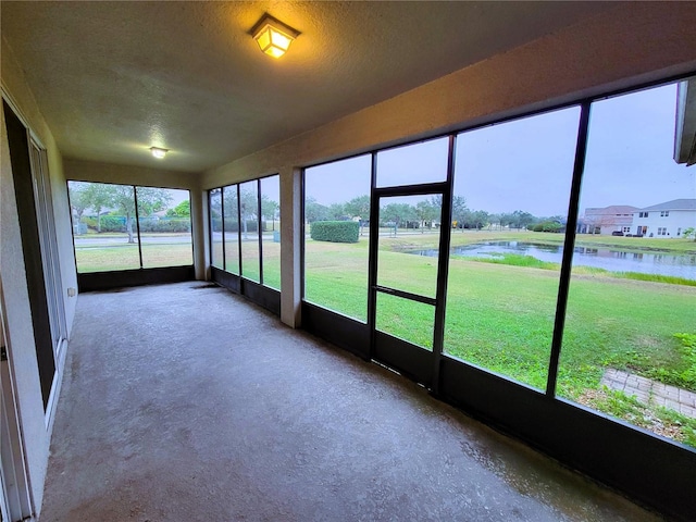 unfurnished sunroom with a water view