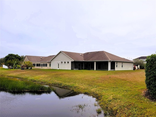 rear view of house with a yard