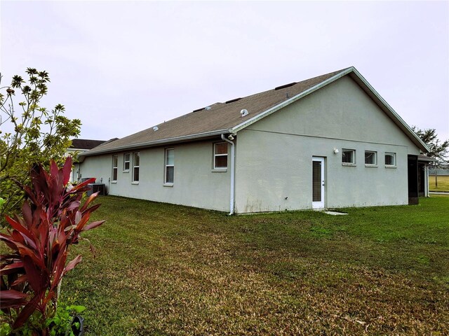 rear view of property featuring a lawn