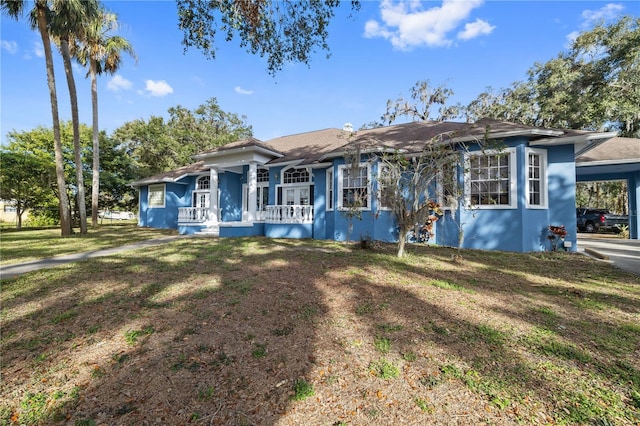 single story home with a carport and a front yard