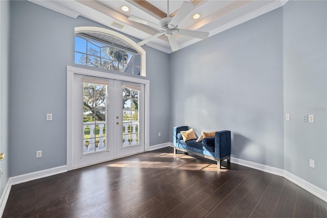 living area featuring ceiling fan, dark wood-type flooring, beam ceiling, and french doors