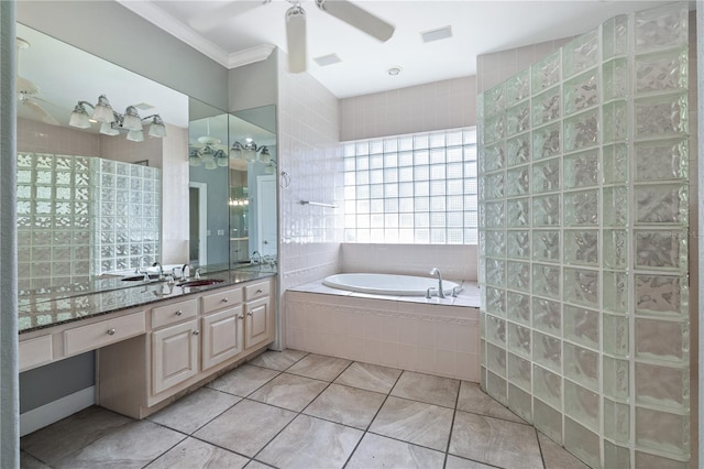 bathroom with tile patterned floors, crown molding, vanity, ceiling fan, and tiled bath