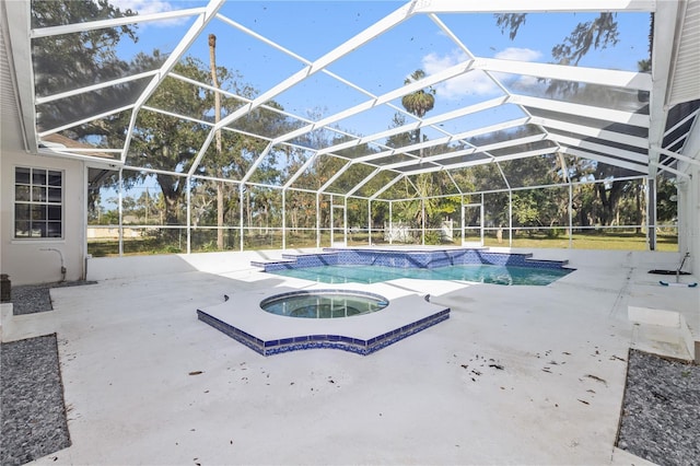 view of pool featuring an in ground hot tub, a lanai, and a patio area