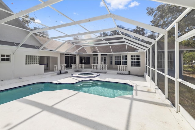 view of swimming pool featuring a patio and glass enclosure