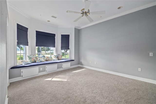 carpeted spare room with ceiling fan and ornamental molding