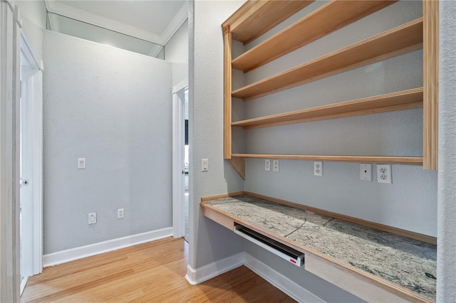 interior space with built in desk and light hardwood / wood-style floors