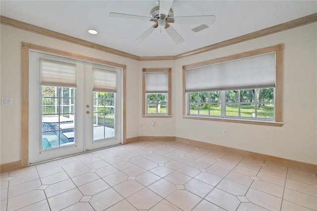 tiled spare room with crown molding, french doors, and ceiling fan