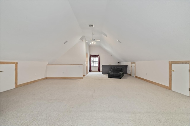 additional living space featuring vaulted ceiling and light carpet