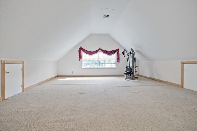 bonus room featuring light colored carpet and vaulted ceiling