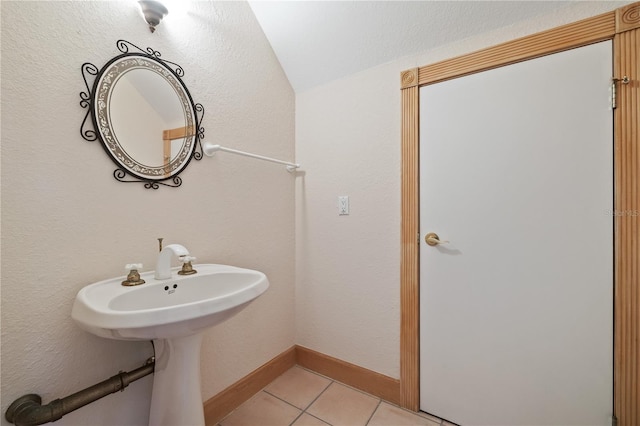 bathroom featuring tile patterned floors and vaulted ceiling