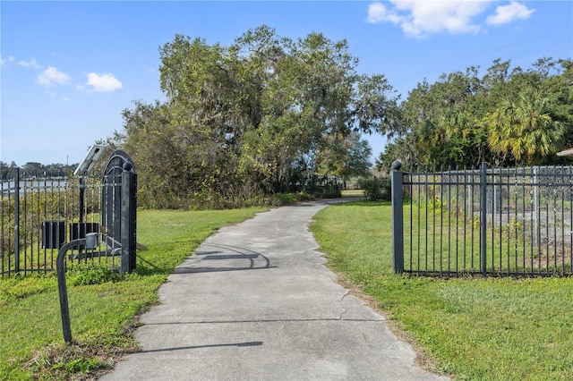 view of gate featuring a yard