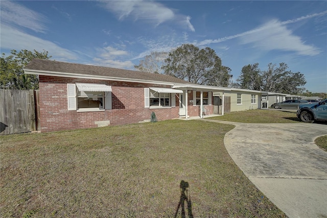 ranch-style home with a front lawn