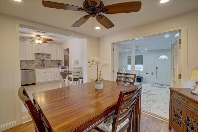 dining room with ceiling fan, light hardwood / wood-style floors, and sink