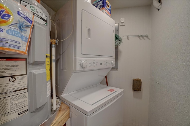 laundry room featuring electric water heater and stacked washing maching and dryer