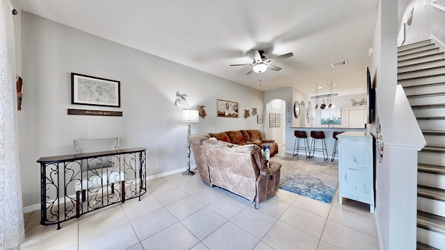 tiled living room with ceiling fan