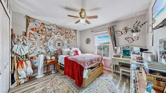 bedroom featuring a closet, ceiling fan, and light hardwood / wood-style floors