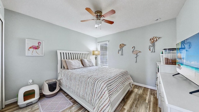 bedroom featuring hardwood / wood-style flooring and ceiling fan