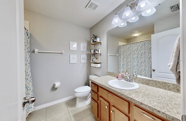 bathroom featuring vanity, tile patterned floors, and toilet