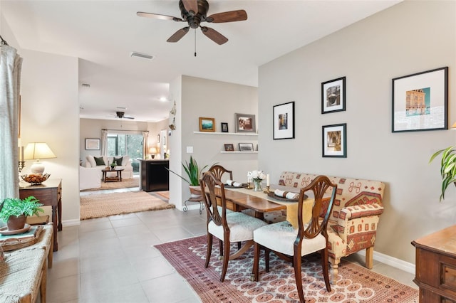 tiled dining room with ceiling fan