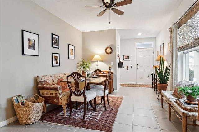 tiled dining area featuring ceiling fan