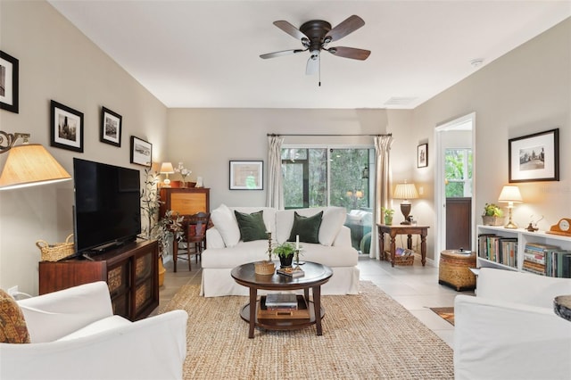 living room with a wealth of natural light, light tile patterned floors, and ceiling fan