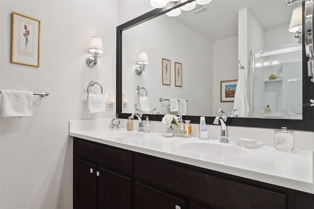 bathroom with walk in shower and vanity