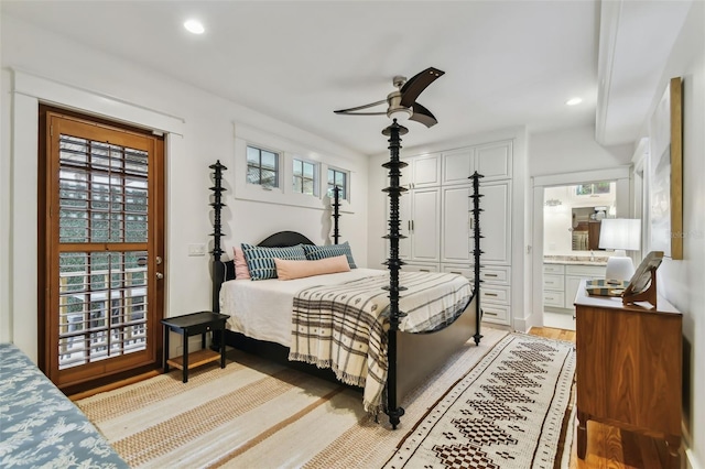 bedroom featuring ceiling fan, connected bathroom, and light hardwood / wood-style floors