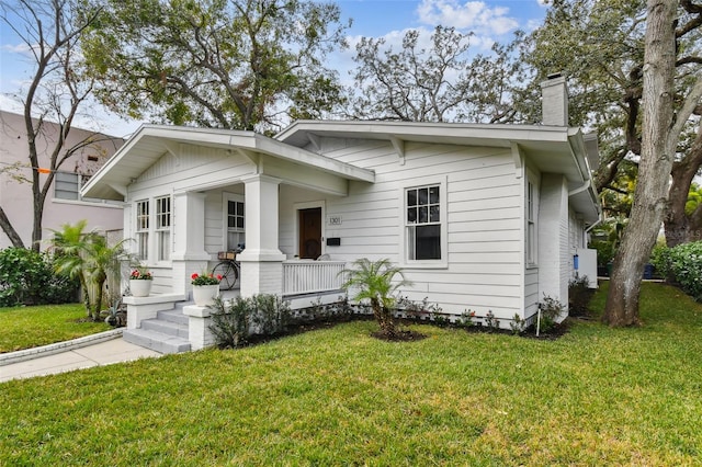 view of front of property featuring a front yard and covered porch