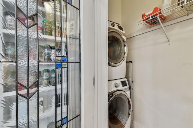 clothes washing area with stacked washer and dryer