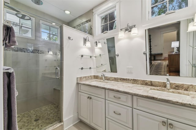 bathroom featuring vanity, an enclosed shower, and tile patterned floors