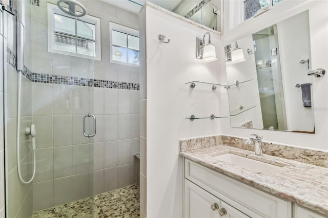 bathroom with an enclosed shower and vanity