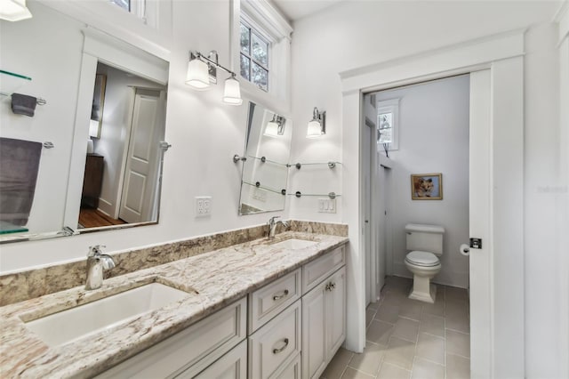 bathroom with vanity, tile patterned floors, and toilet