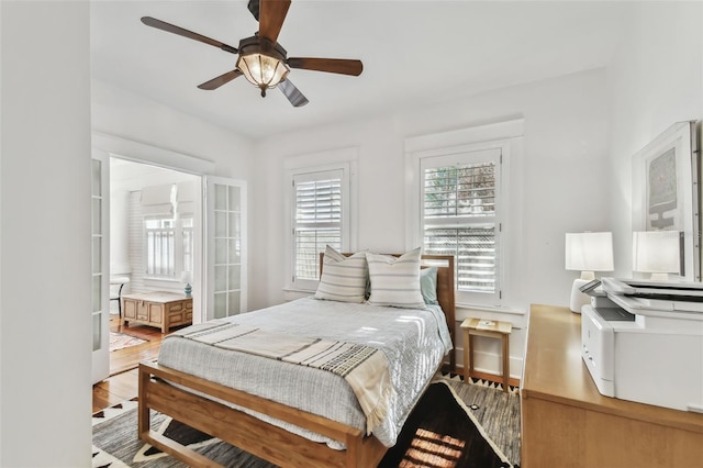 bedroom featuring wood-type flooring, ceiling fan, and ensuite bathroom