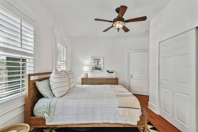 bedroom featuring hardwood / wood-style flooring, a closet, and ceiling fan