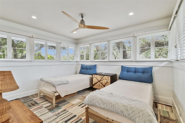 sunroom featuring ceiling fan