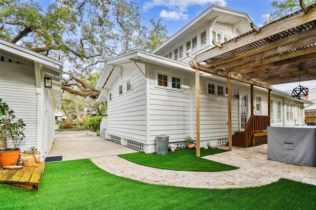 back of house with a patio area and a lawn