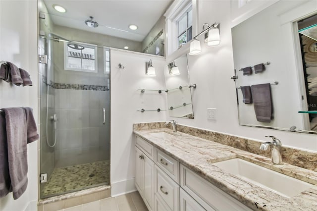 bathroom featuring vanity, tile patterned floors, and a shower with shower door