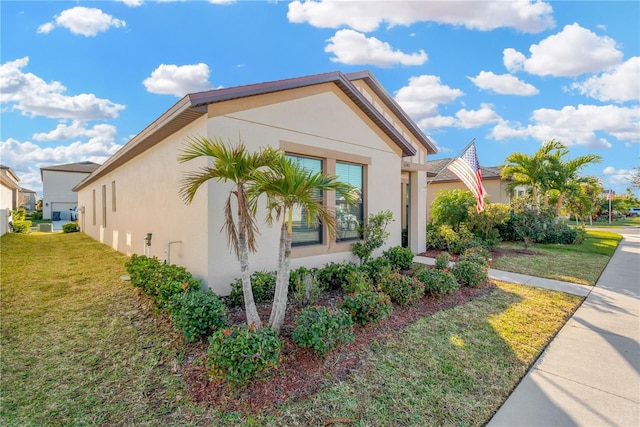 view of side of home with a yard