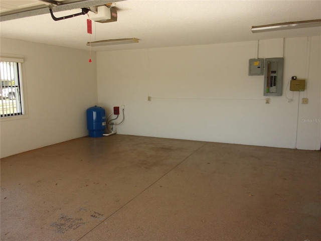 garage with a garage door opener and electric panel