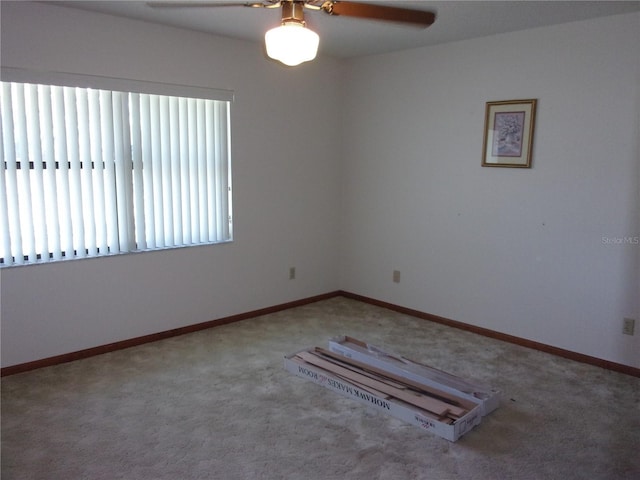 unfurnished room featuring ceiling fan and carpet