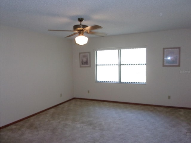 spare room featuring carpet floors and ceiling fan