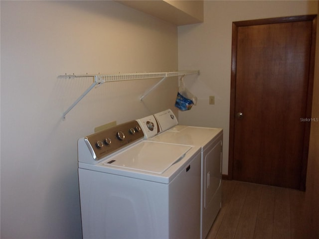 laundry room featuring hardwood / wood-style flooring and washing machine and clothes dryer