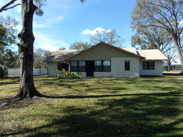 back of house with a yard