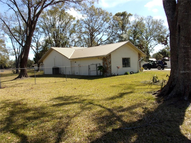 view of side of property with a yard