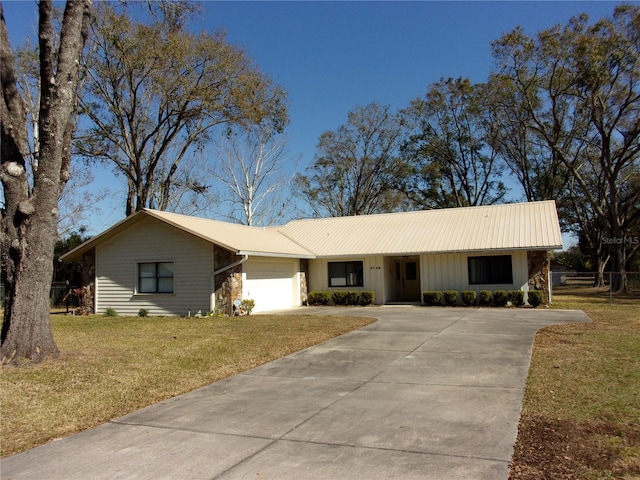 single story home featuring a garage and a front yard