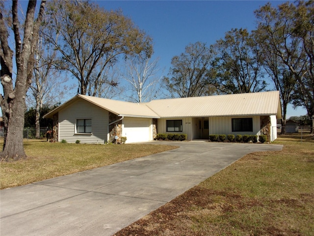 single story home with a garage and a front lawn