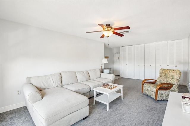 carpeted living room featuring ceiling fan