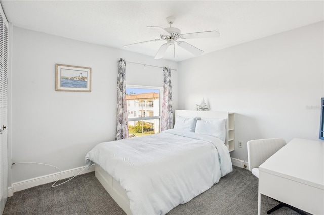 bedroom featuring ceiling fan and dark carpet