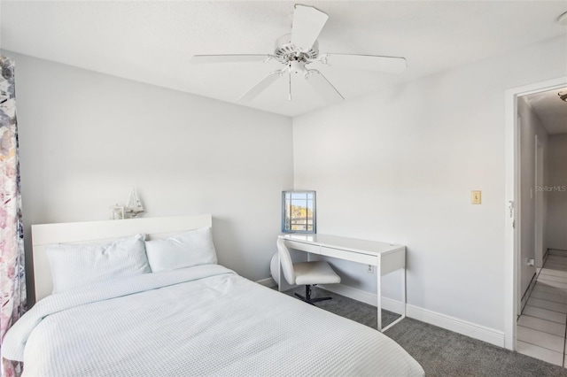 bedroom with ceiling fan and dark colored carpet